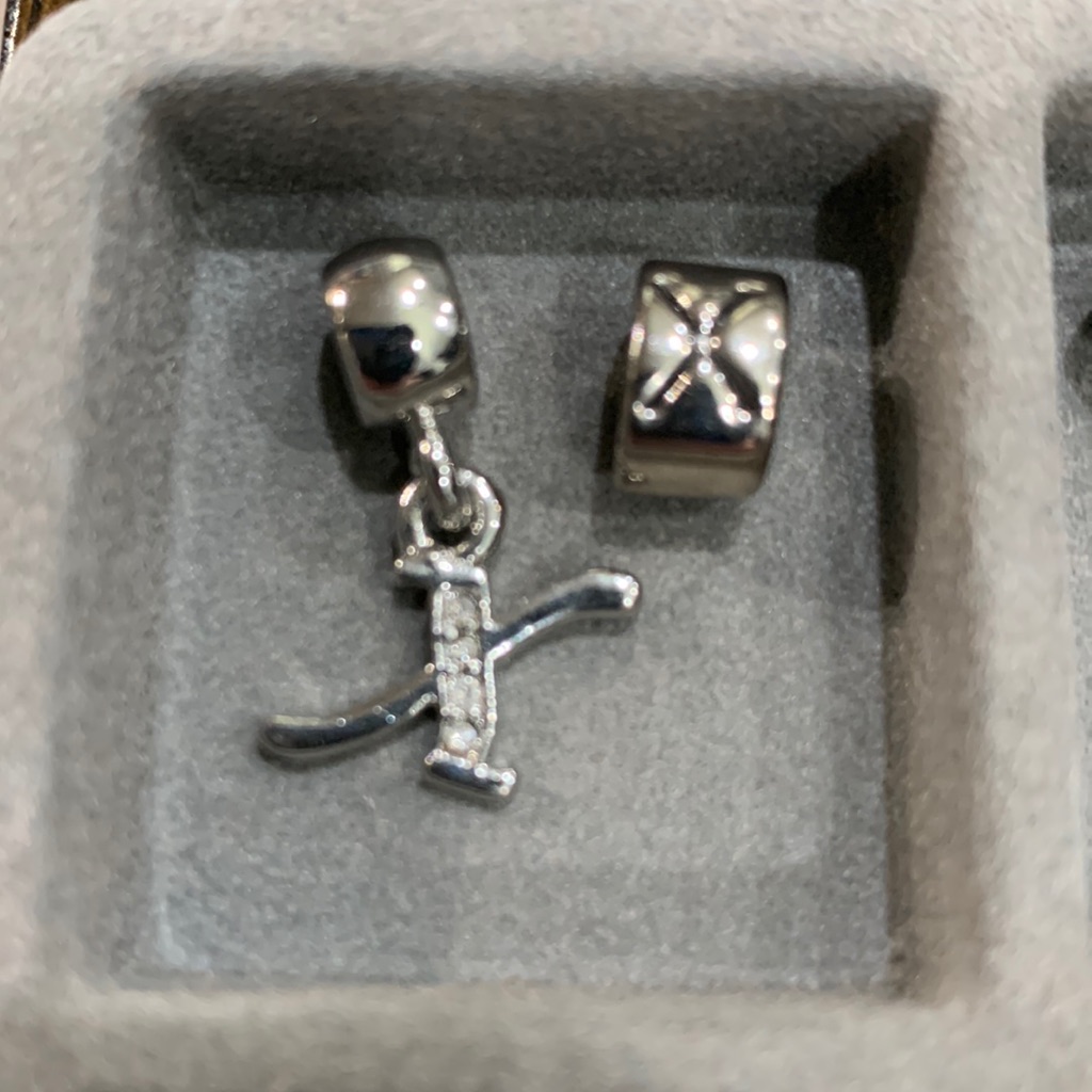 X Initial Charm